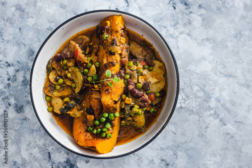 plant-based food, vegan butternut squash roast with beans and mixed mediterrnean vegetables in spicy broth photo