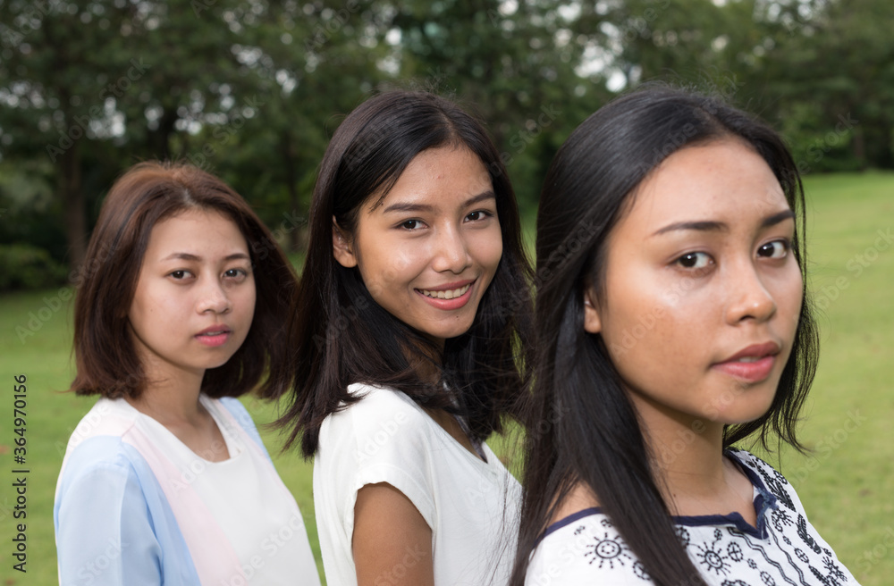 Portrait of three young beautiful Asian teenage girls as friends together at the park Portrait of three young beautiful Asian teenage girls as friends together at the park