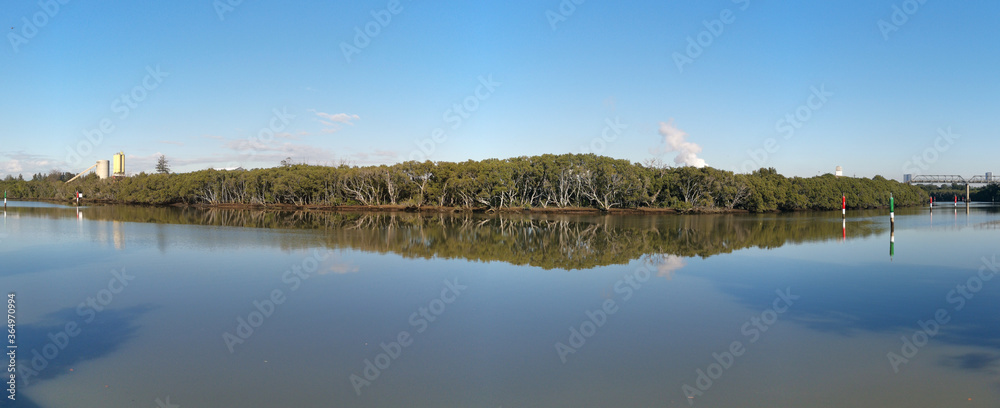 beautiful early morning panoramic view of river with reflections of blue sky, clouds and trees on water, Parramatta river, Rydalmere, New South Wales, Australia