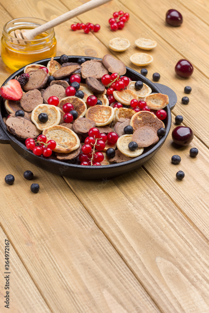 Frying pan with cereal pancakes. Flour, berry yogurt, butter, honey jam. Frying pan with cereal pancakes. Flour, berry yogurt, butter, honey jam.