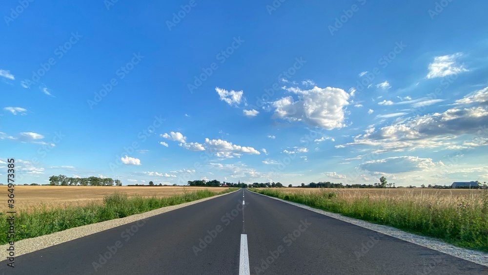 Road in Poland. Polish village, cottage. Sunny day Lubusz district. Clouds, route