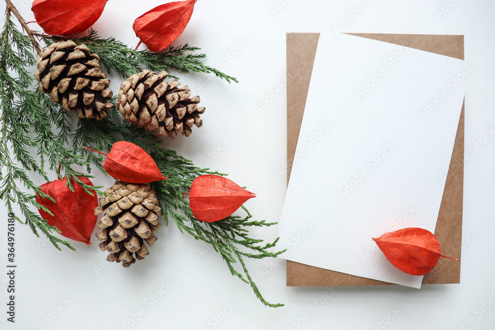 new year card layout. spruce branch with cones on a white background and place for text. invitation. congratulation