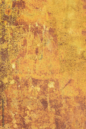 Old rusty metal surface with yellow and brown paint flaking and cracking texture  may used as background.