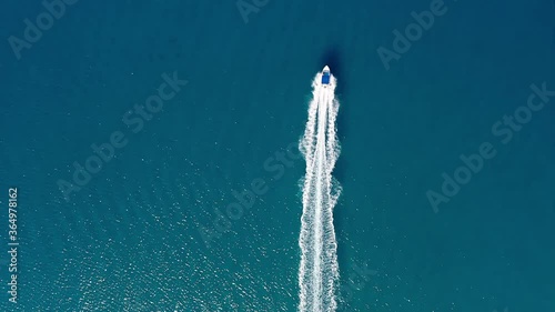 Overhead view of a small fishing boat in the blue sea