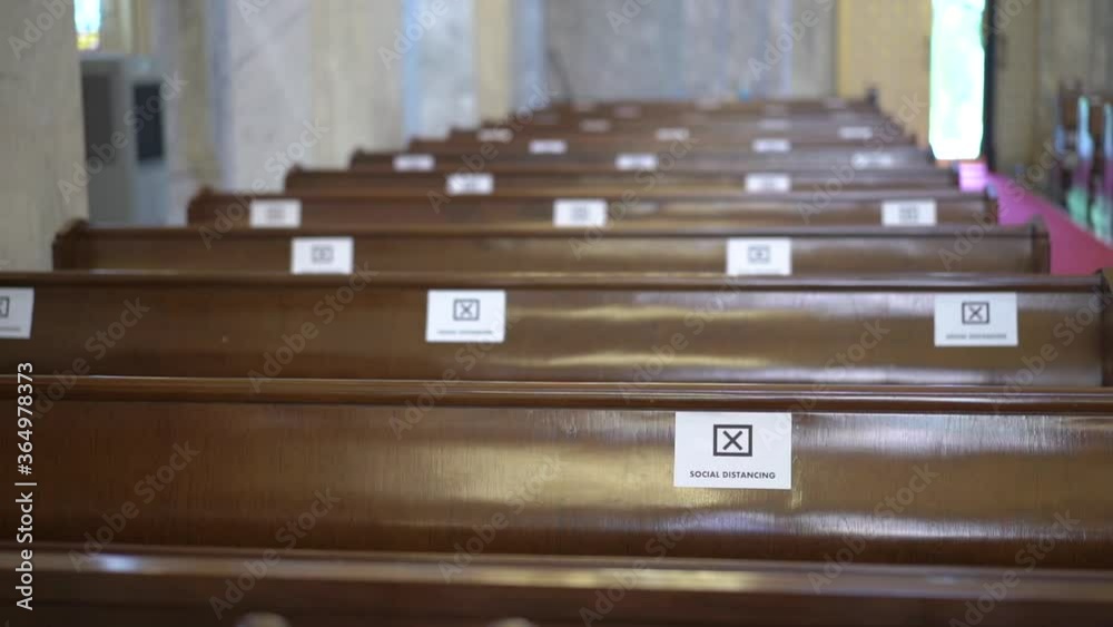 Label on wooden chair Social distancing inside Catholic church .Ways to prevent Covid 19 in Thailand 4