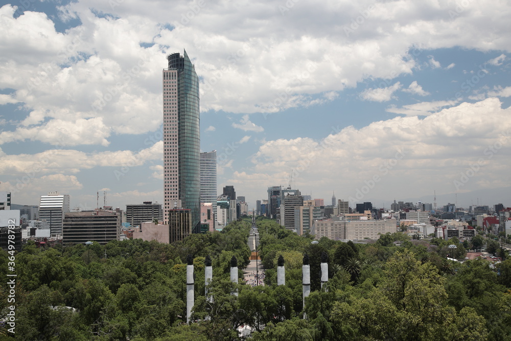 Fototapeta premium View of Mexico city skyline along Paseo de la Reforma avenue as seen from Chapultepec Castle in Mexico city, Mexico.