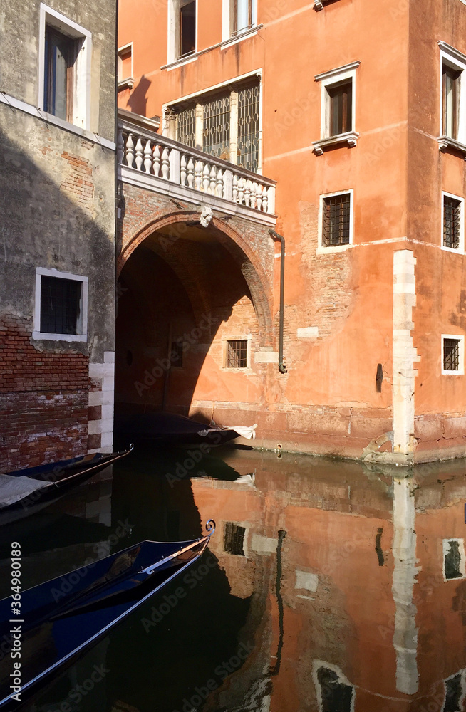 View of the canal and the building with windows in Venice. Beautiful sea landscape with canals and architecture of Venice. Vertical image.