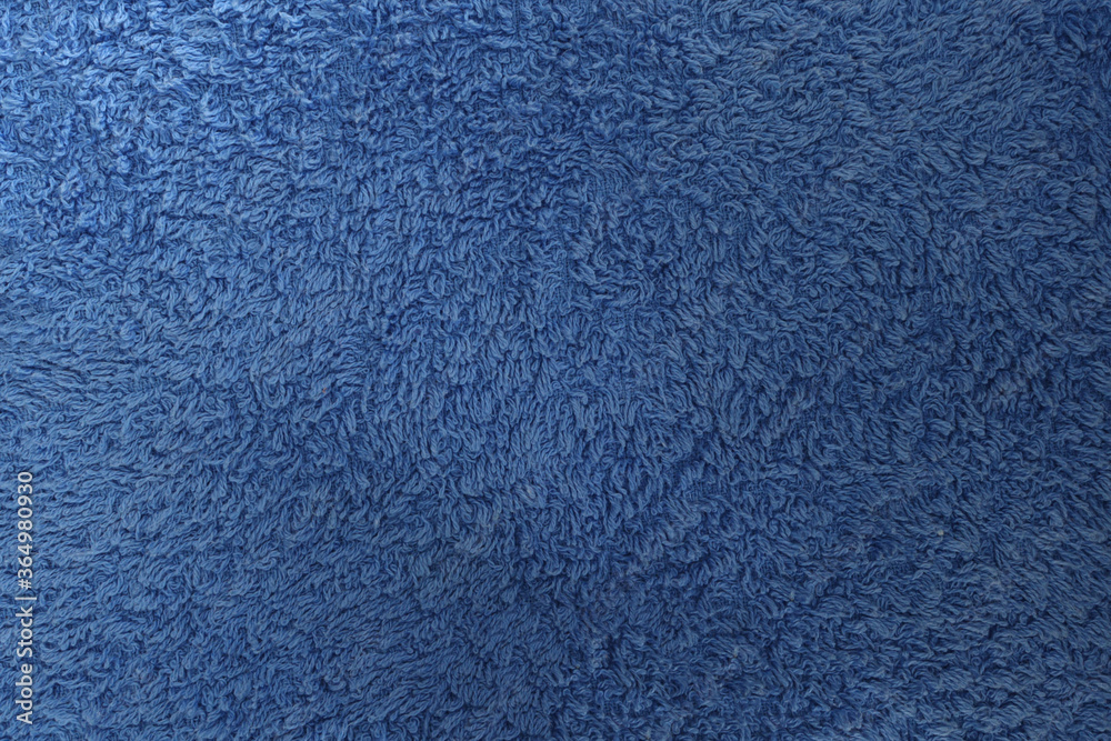 Blue fabric. Texture of a towel terry cloth or terry textile background Blue fabric. Texture of a towel terry cloth or terry textile background