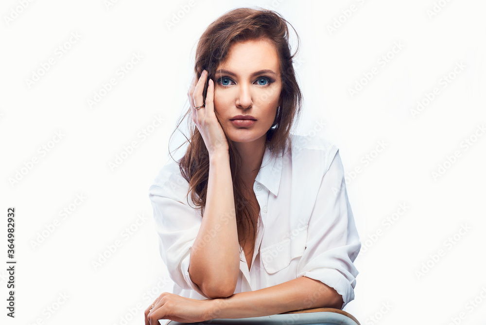 bright portrait of a beautiful woman on a white background in a light shirt, looking up, hands took faces bright portrait of a beautiful woman on a white background in a light shirt, looking up, hands took faces