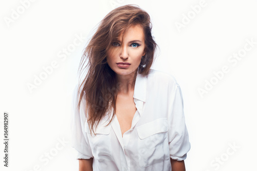 close-up portrait of a beautiful woman on a white background in a light shirt © bodiaphoto