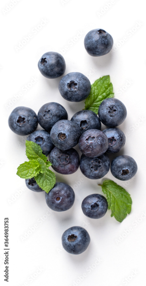 Blueberry fruit top view isolated on a white background, flat lay overhead layout with mint leaf, healthy design concept. Blueberry fruit top view isolated on a white background, flat lay overhead layout with mint leaf, healthy design concept.