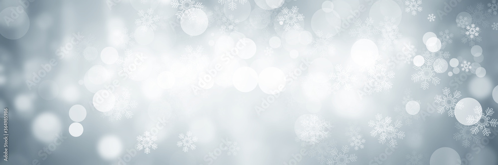 wide white and gray Christmas light with snowflake bokeh background, Winter backdrop wallpaper.