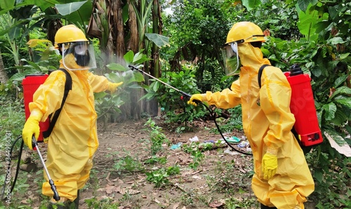 Health workers dressed in hazmat are spraying disinfectants
