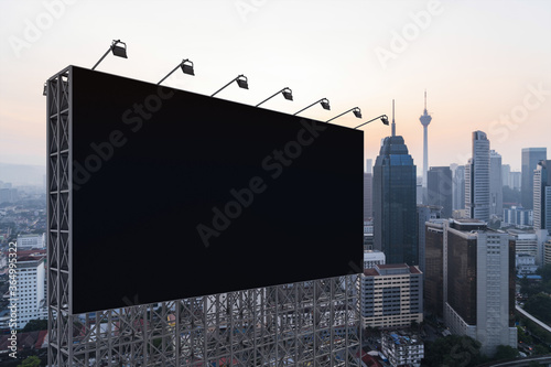 Photography Blank black road billboard with KL cityscape background at sunset