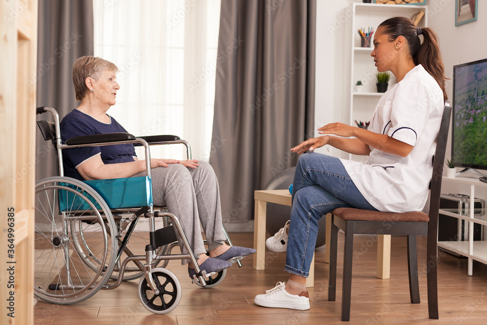 Nurse checking on retired handicapped old woman. Disabled handicapped old person recovering professional help nurse, nursing retirement home treatment and rehabilitation Nurse checking on retired handicapped old woman. Disabled handicapped old person recovering professional help nurse, nursing retirement home treatment and rehabilitation