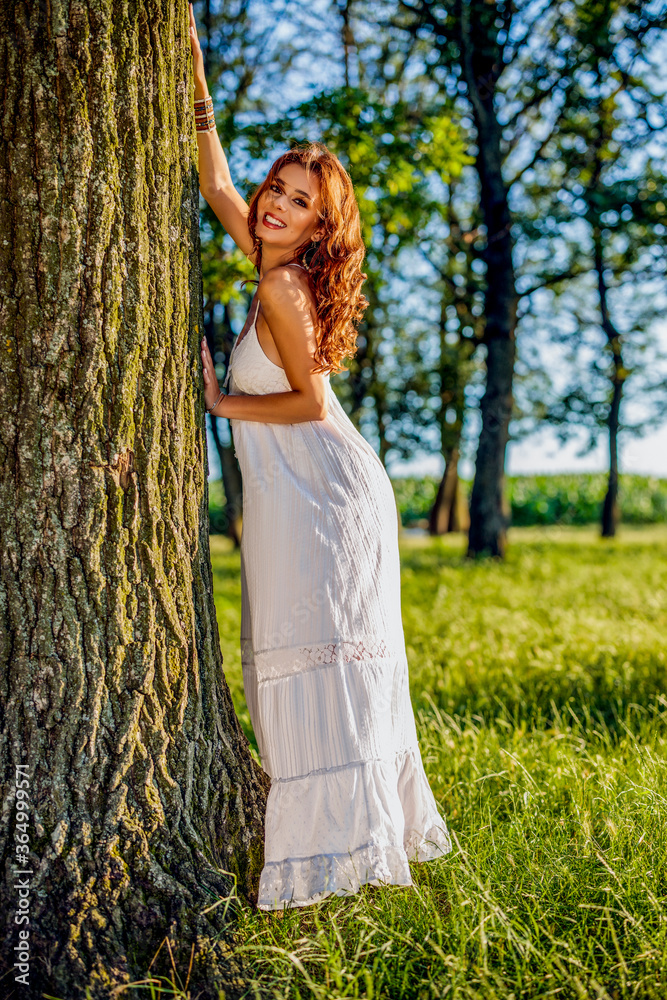 Beautiful woman near a tree at summer day, outdoors portrait Beautiful woman near a tree at summer day, outdoors portrait