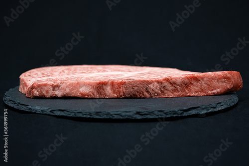 黒い皿に乗った新鮮なステーキ肉