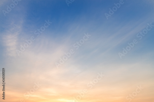 blue bright dramatic sunset sky in countryside or beach colorful cloudscape texture air background. © Thinapob