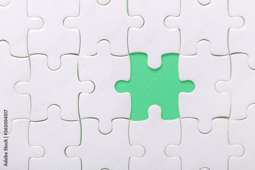 White puzzle background with one piece missing. Close-up. Concept success of business White puzzle background with one piece missing. Close-up. Concept success of business