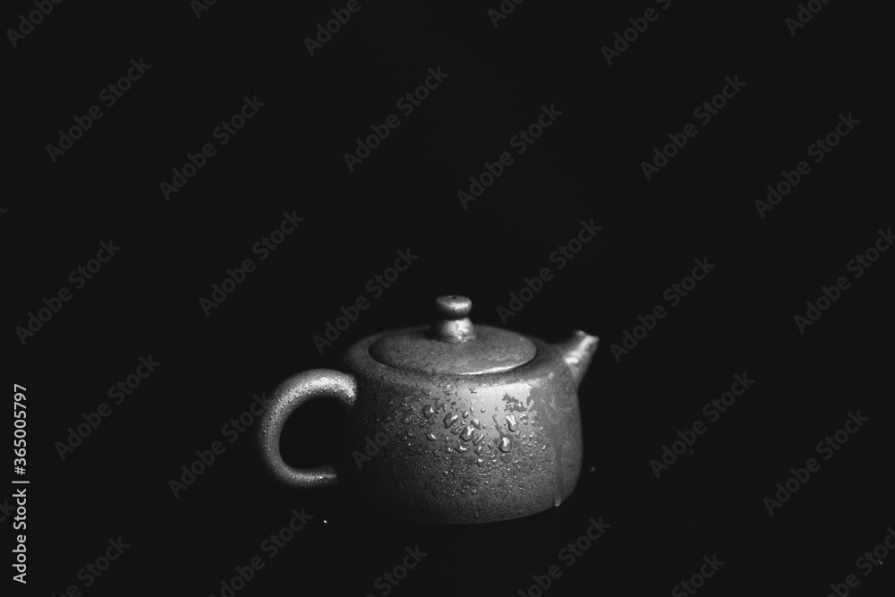 black and white photo of a ceramic teapot and tea ceremony