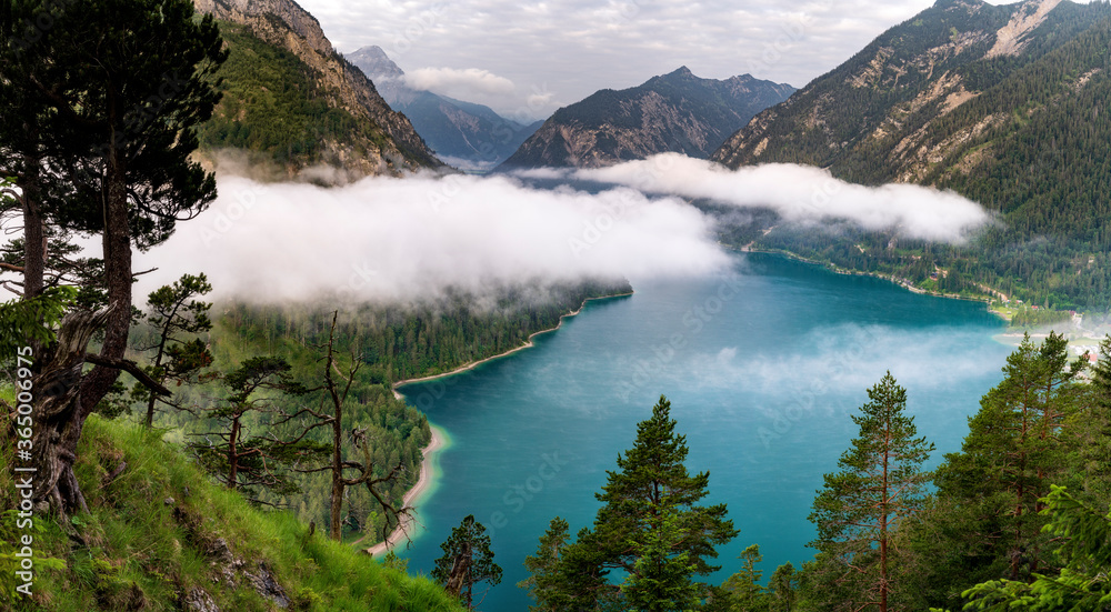Lake Plansee in Austria Tirol in the morning with fog. Hiking in the alps near Reutte. Holiday 