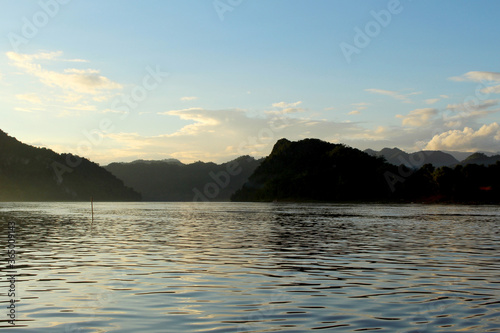 Mekong river flowing at dusk with moutains behind