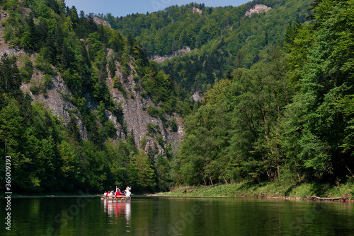 Raftsman rafts tourists on the Dunajec river gorge. Rafting on Dunajec river in Poland.