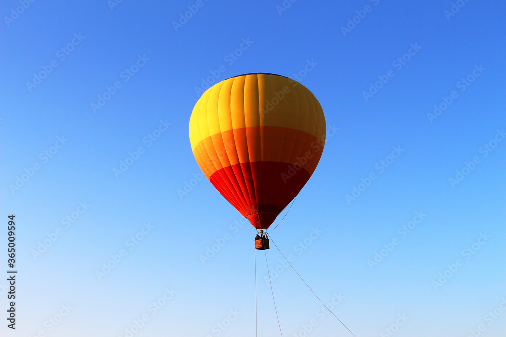 Colorful air balloon flying in the middle of blue sky Colorful air balloon flying in the middle of blue sky