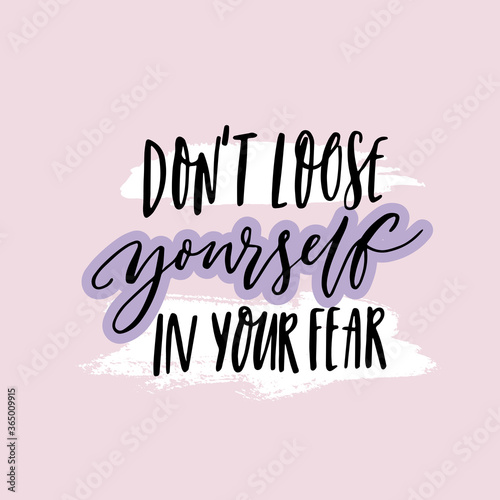 Don't loose yourself in your fear. Inspirational quote about anxiety. Positive motivational saying. Handwritten text on purple background.