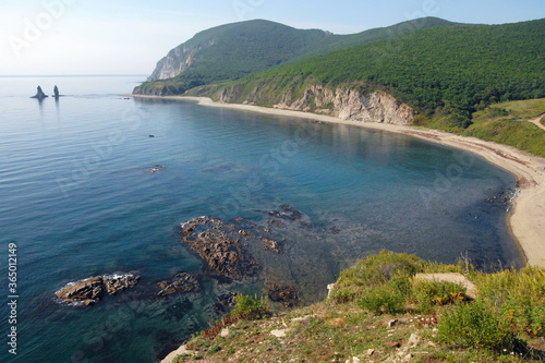 View at Rudnaya bay of Sea of Japan and Two Brothers (also Two Fingers) stack (or sea stack, rock, island). Outskirts of Rudnaya Pristan town, Primorsky Krai (Primorye), Far East, Russia.