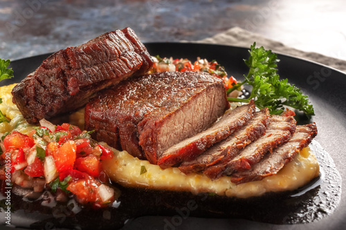 Photography Beef medallions with tomato salsa and cream polenta