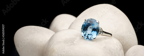 Classy blue ring close-up on top of white stones photo