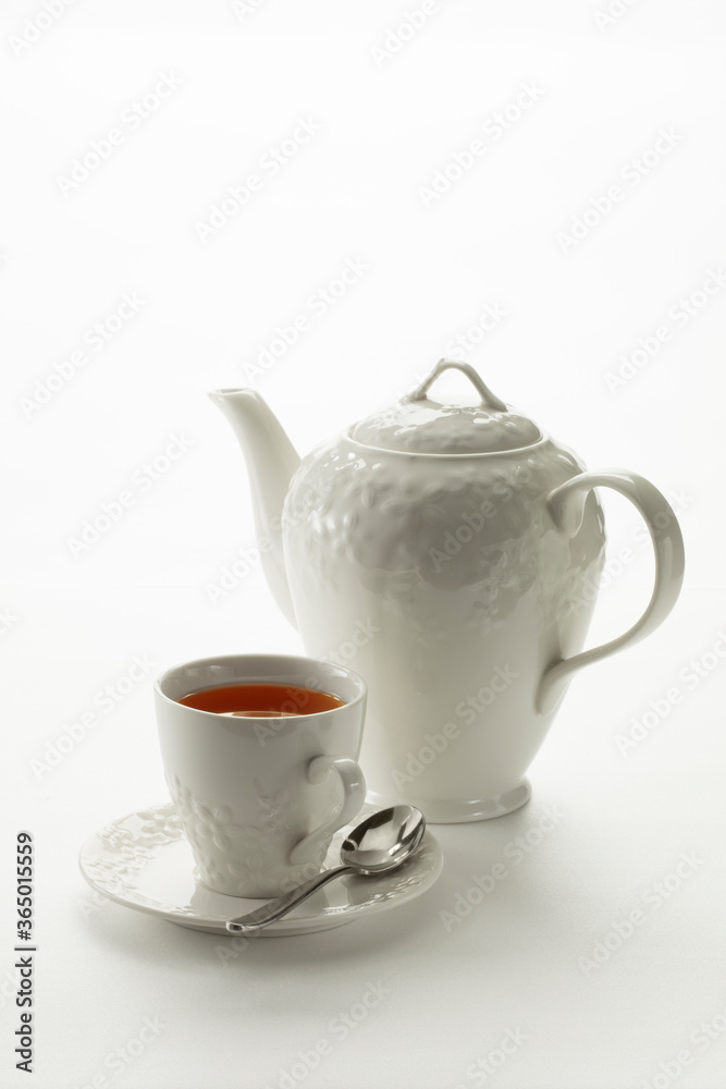 Close up view of china teapot and cup on white background