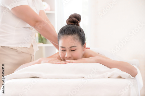 A beautiful Asian woman is comfortably relaxed and sleep in a spa shop after the masseuse has massaged her body