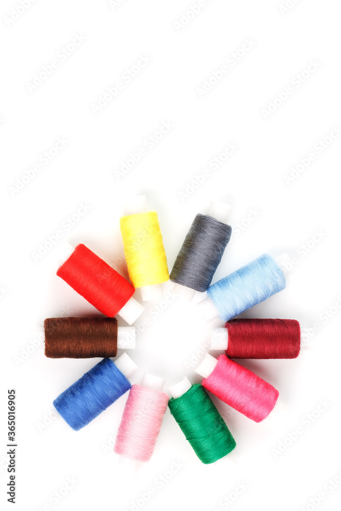 Colorful cotton craft sewing threads in flower shape isolated on white background. Colorful cotton craft sewing threads in flower shape isolated on white background.