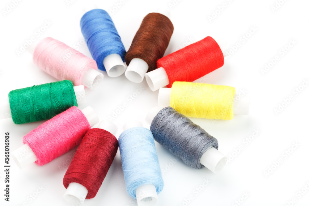Colorful cotton craft sewing threads in flower shape isolated on white background. Colorful cotton craft sewing threads in flower shape isolated on white background.
