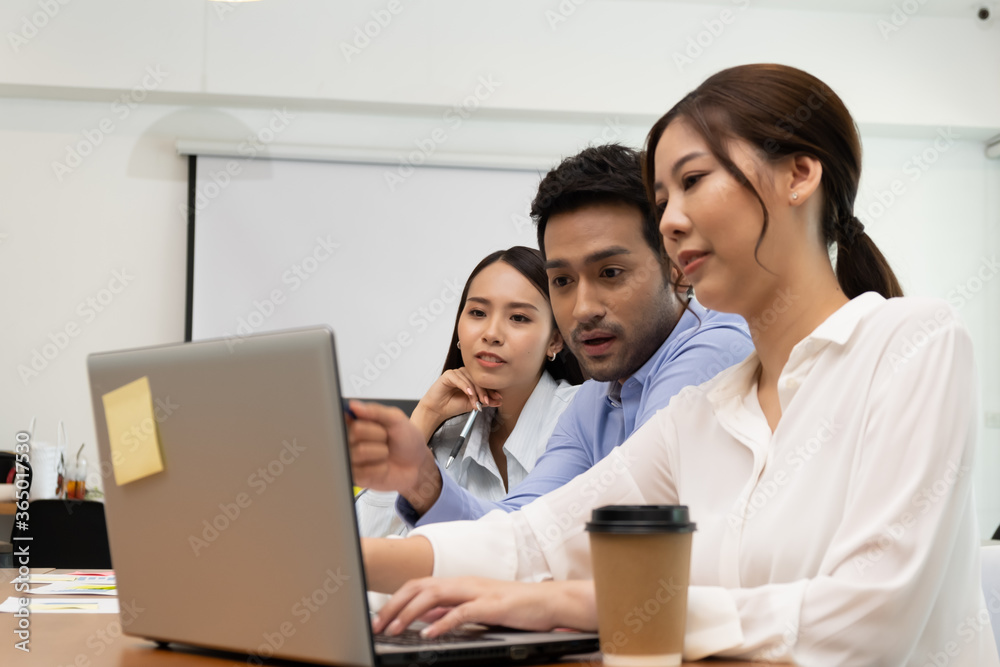 Young business group explaining new business ideas to peers. Business people discussing in meeting room. Young business group explaining new business ideas to peers. Business people discussing in meeting room.
