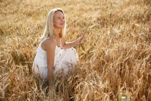 Fototapeta Naklejka Na Ścianę i Meble -  Beautiful girl in a white dress. Woman in a summer field