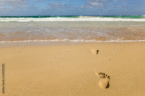 One set of footprints in the sand, going towards the water. A concept of disappearing into thin air and never turning back up. Also a concept about suicide. The prints are in contrast with the sand.