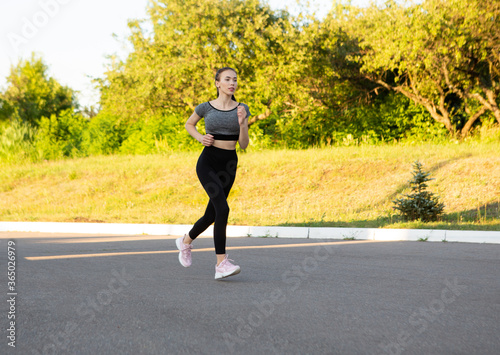 Side view of active sporty young running woman runner.