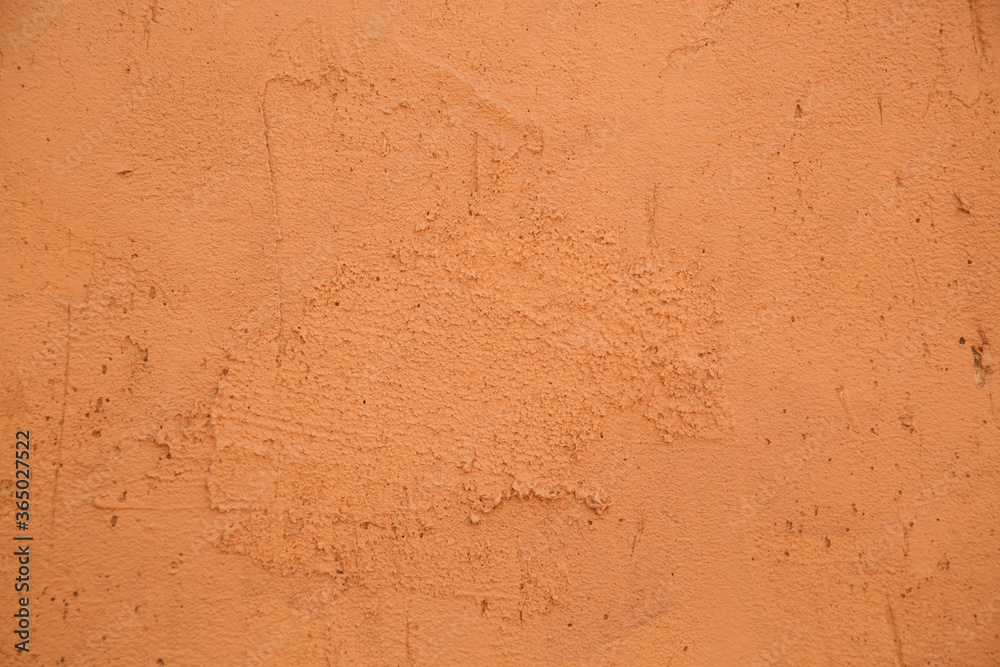 close-up of the clay wall of a terracotta-colored village house, texture close-up of the clay wall of a terracotta-colored village house, texture