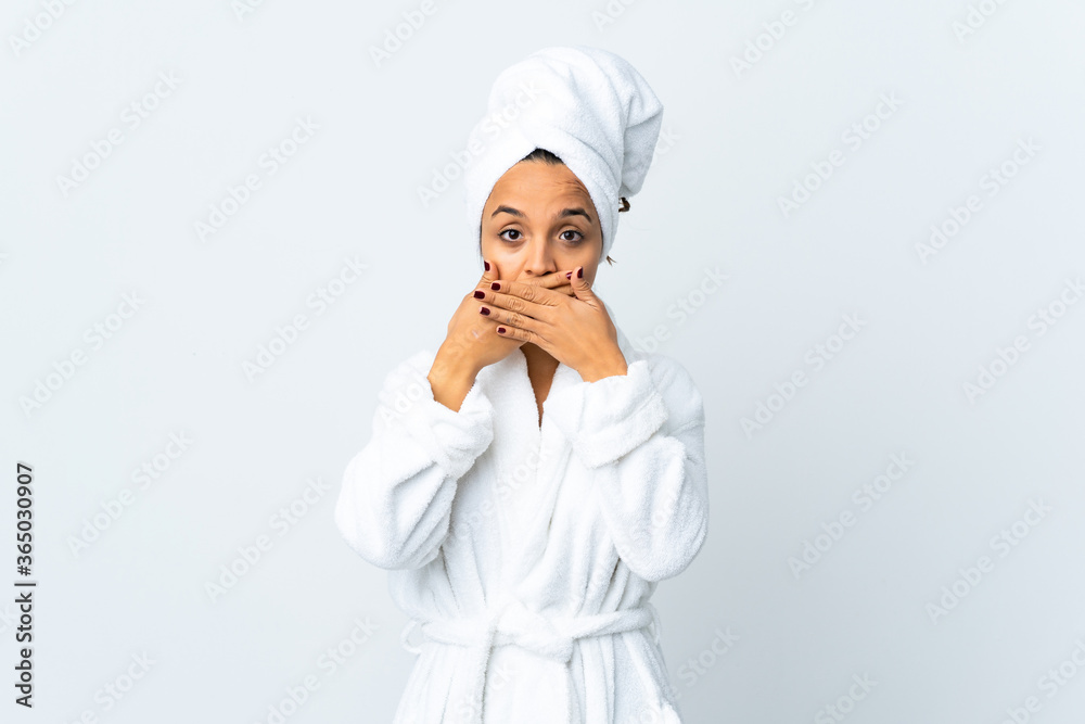 Young woman in bathrobe over isolated white background covering mouth with hands Young woman in bathrobe over isolated white background covering mouth with hands