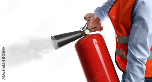 Worker using fire extinguisher on white background, closeup photo