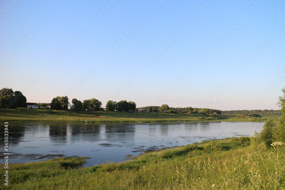 Sunny evening on the river in the countryside