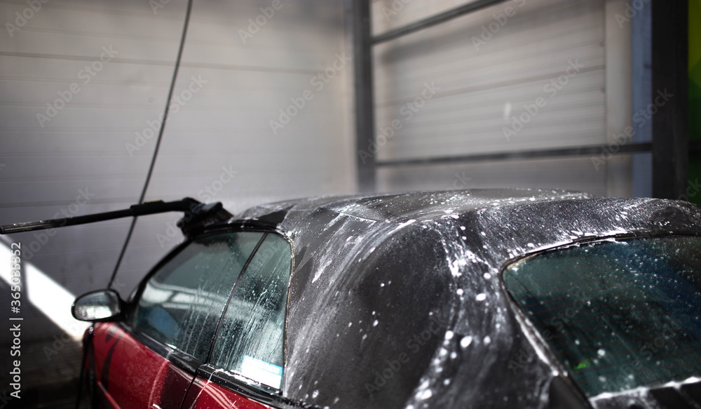 Αυτοκόλλητο washing a cabriolet car, cleaning the tarpaulin roof with foam.