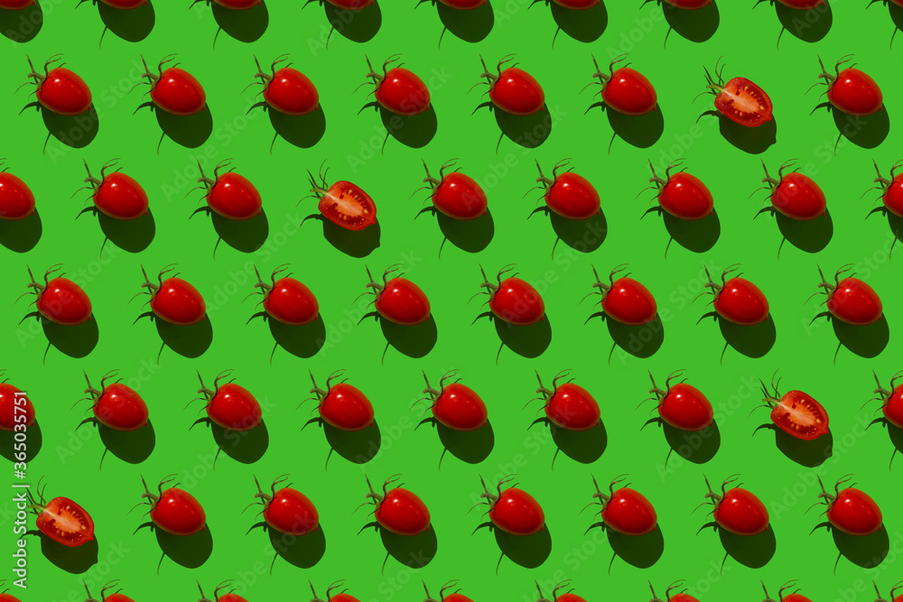 Pattern of Bulgarian sweet peppers, cherry tomatoes and cucumbers on a green background