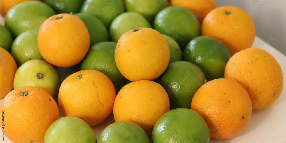 Beautiful lemons and oranges arranged on a table. A fruit rich in vitamin c. Beautiful lemons and oranges arranged on a table. A fruit rich in vitamin c.