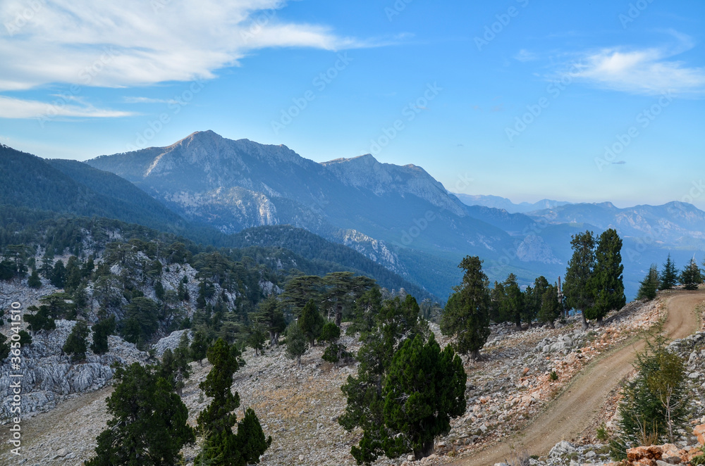 View to mountain ridge in Taurus Mountains, stony hills with rock on green mountain meadow from famous Lycian Way tourist path in Turkey