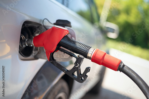 Tableau sur toile Fuel nozzle in the car gas tank close up.