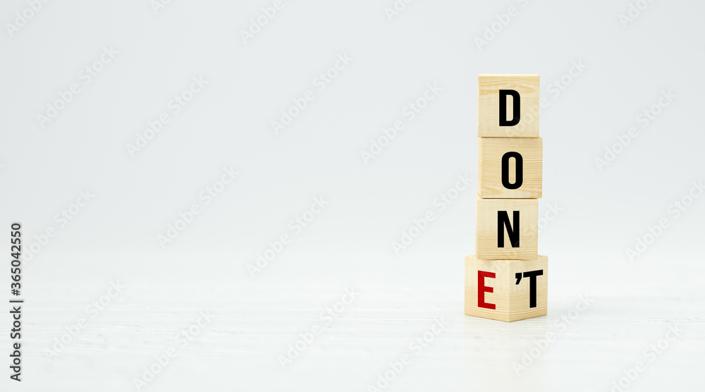 cubes with the words DON'T and DONE on white background cubes with the words DON'T and DONE on white background